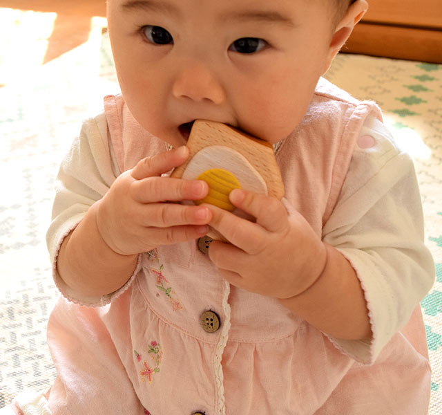 エッグトーストのラトルを持つ赤ちゃん